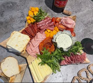 A board of cheeses,
deli meats and dips