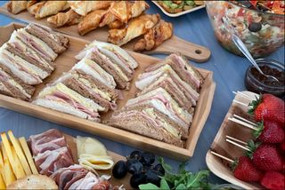 A table of sandwhiches and
fruit